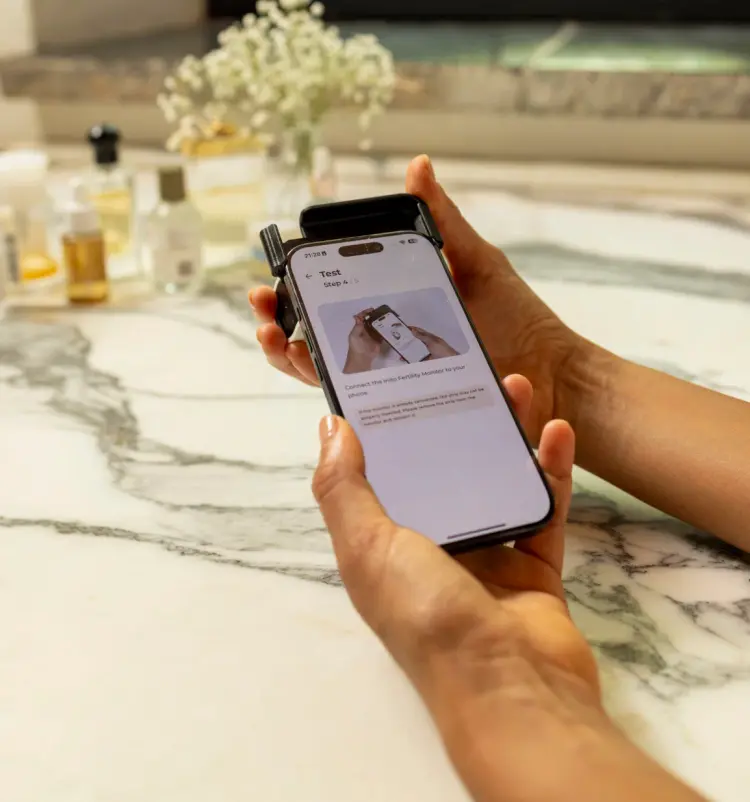 Attach the Inito Fertility tracker to your iPhone.